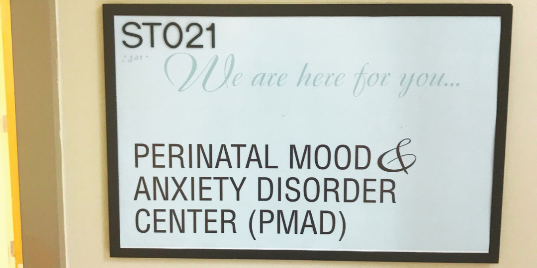 Wall sign reading Perinatal Mood and Anxiety Disorder Center (PMAD)